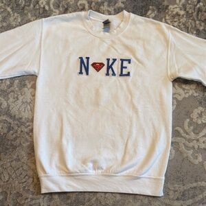 Unisex Nike Superman White Crewneck Sweater with Blue Accents Size Small